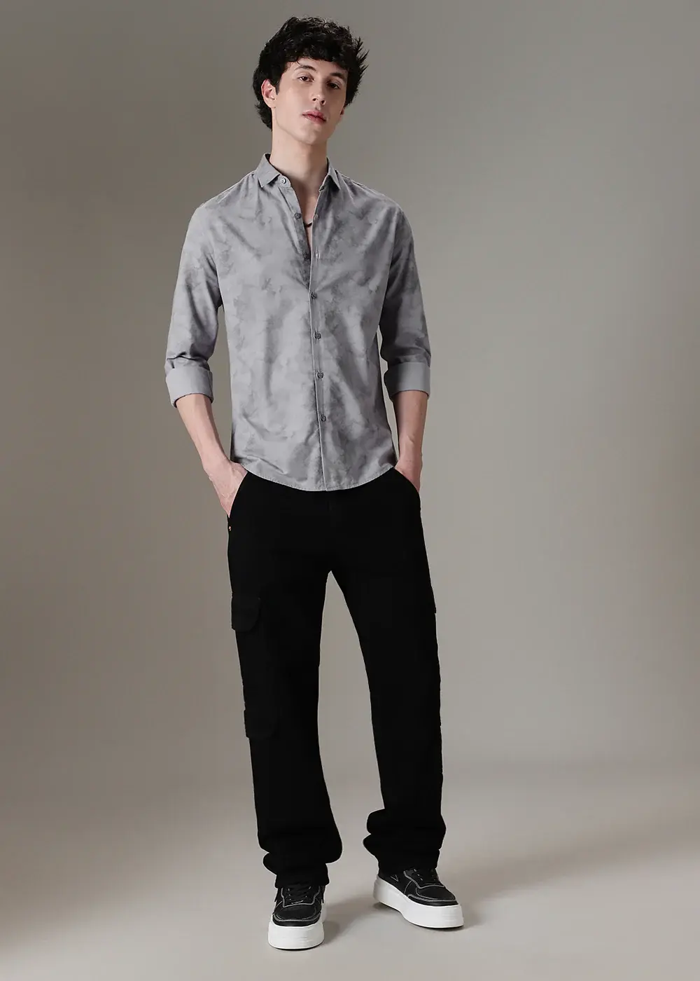 grey shirt with black pants